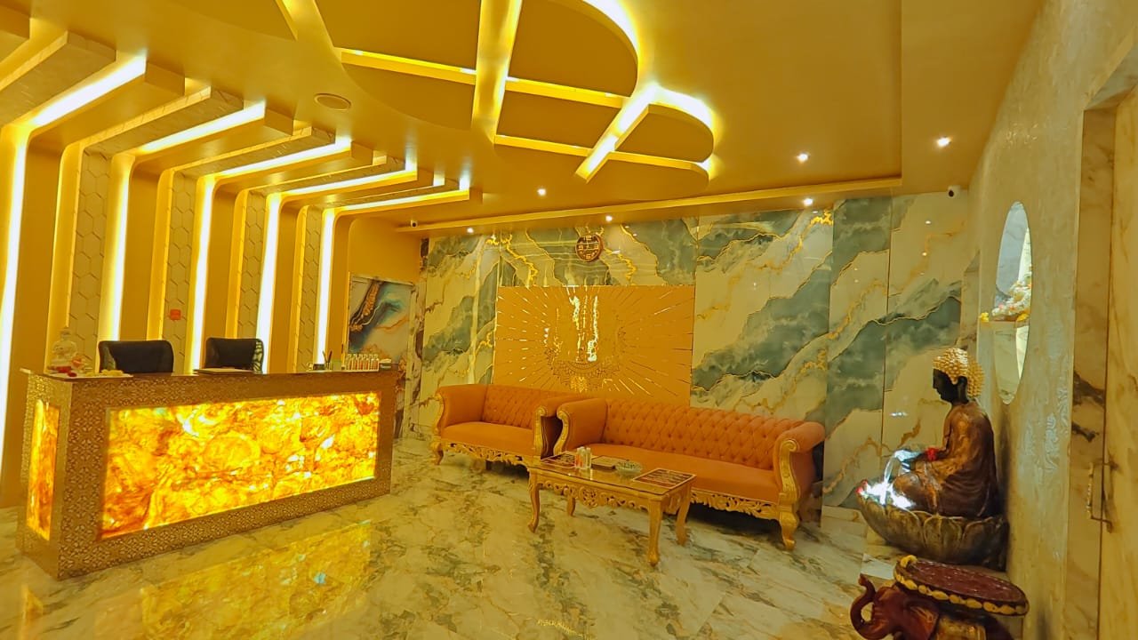 Dream Premium Spa lobby on Sarjapur Road, Bengaluru — glowing reception desk, gold-lit ceiling, marble walls and velvet seating